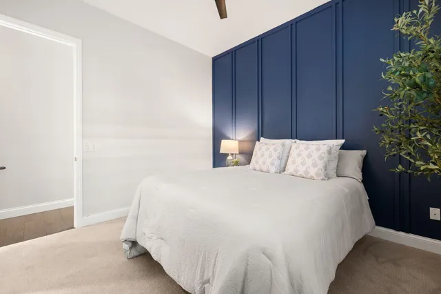 a bedroom with bed and wooden closet