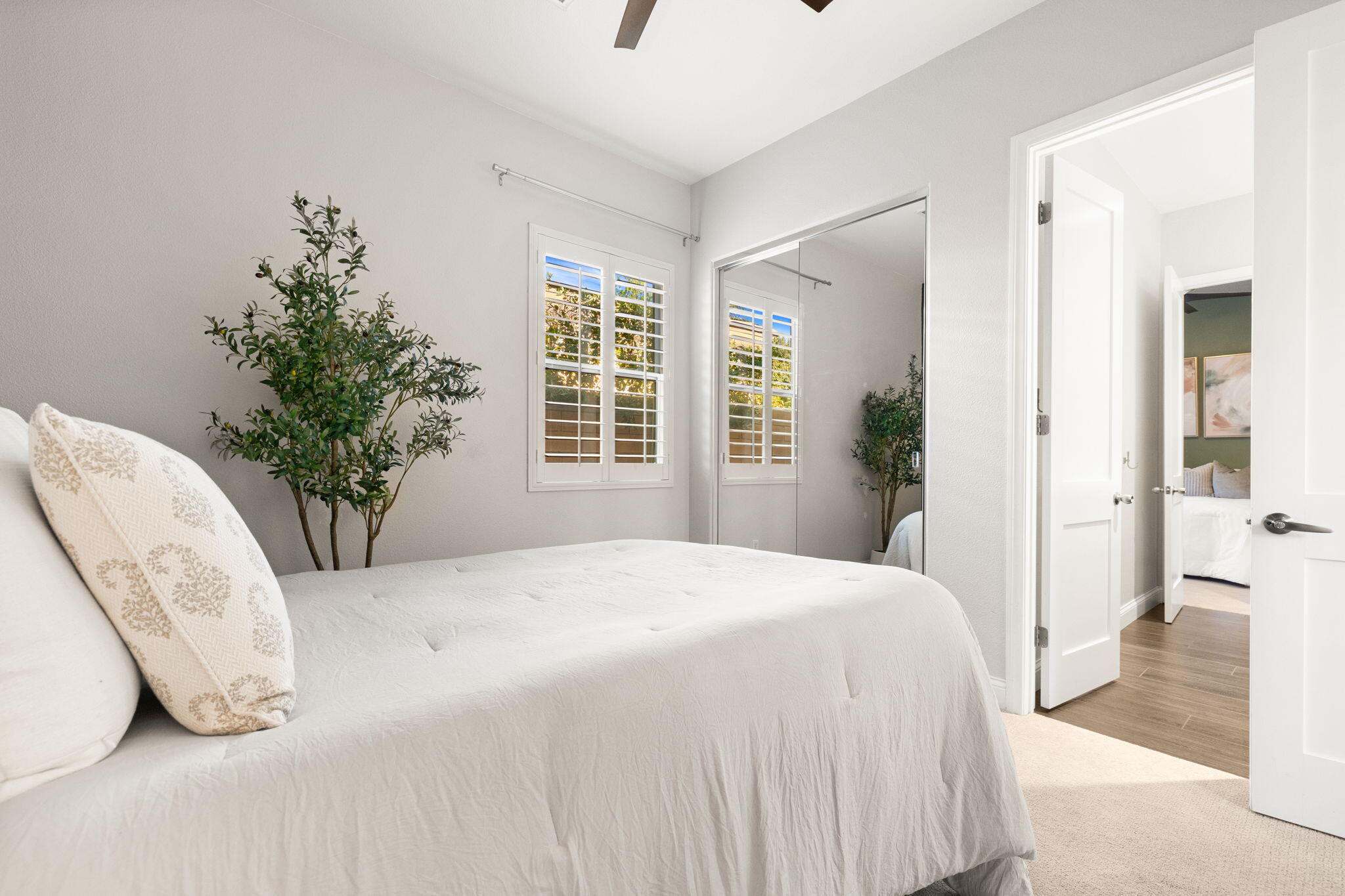 48864 Pear Street Indio, CA 92201 - Photo 34 of 46 a bedroom with a large bed and a potted plant