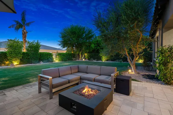 a view of a yard with furniture and a fire pit