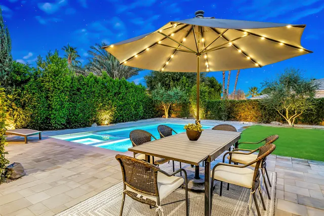 a view of an outdoor sitting area with furniture and backyard