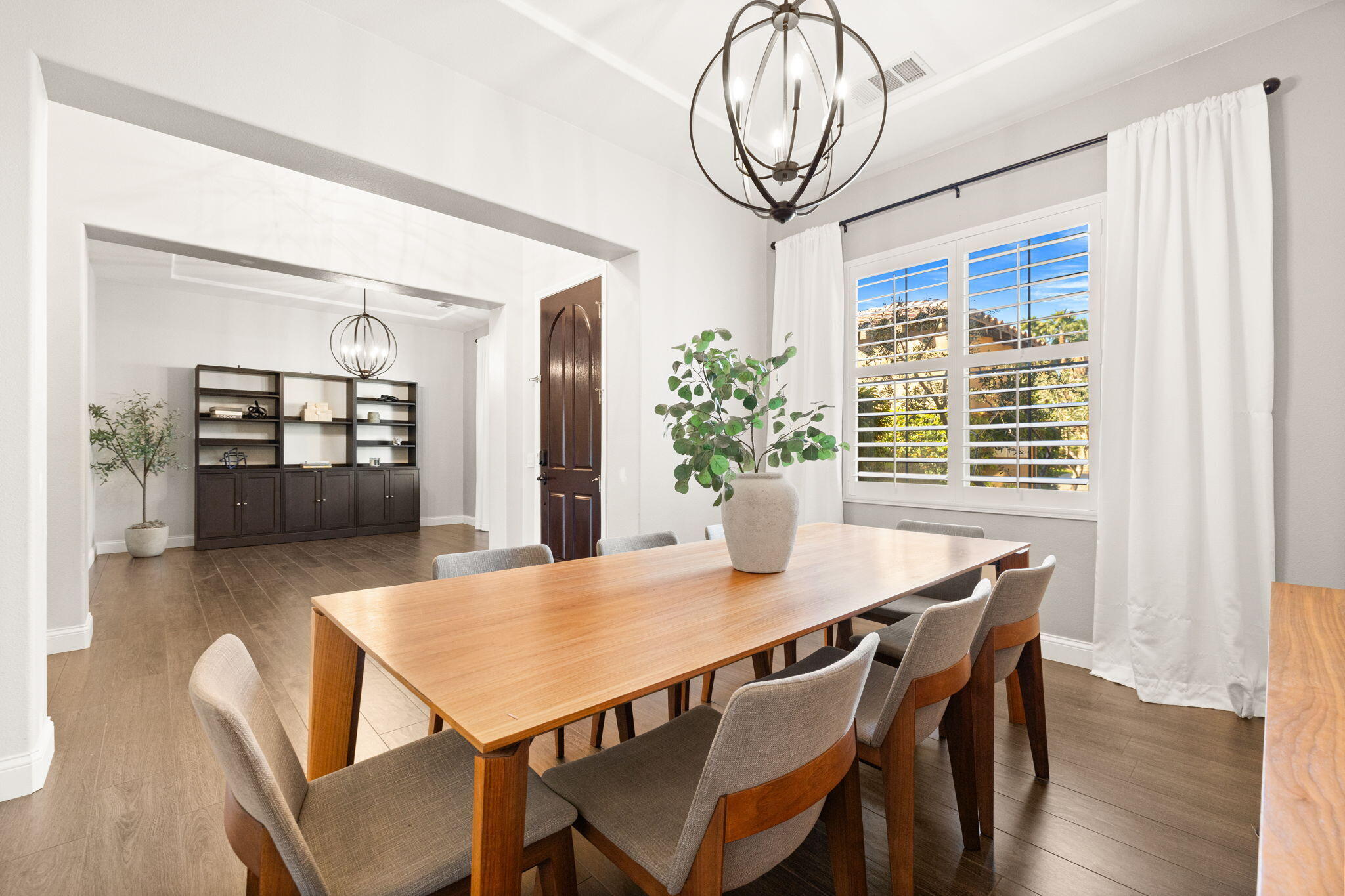 48864 Pear Street Indio, CA 92201 - Photo 4 of 46 a view of a dining room with furniture window and wooden floor