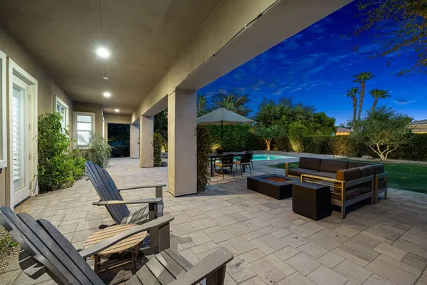 a view of a patio with couches and potted plants
