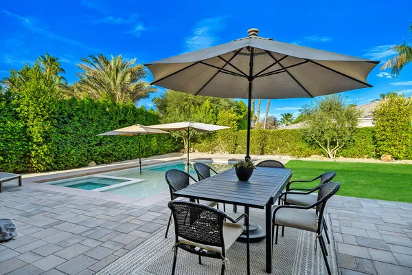 a view of an outdoor sitting area with furniture and umbrella