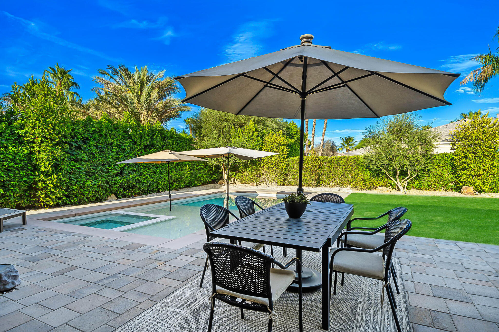48864 Pear Street Indio, CA 92201 - Photo 44 of 46 a view of an outdoor sitting area with furniture and umbrella