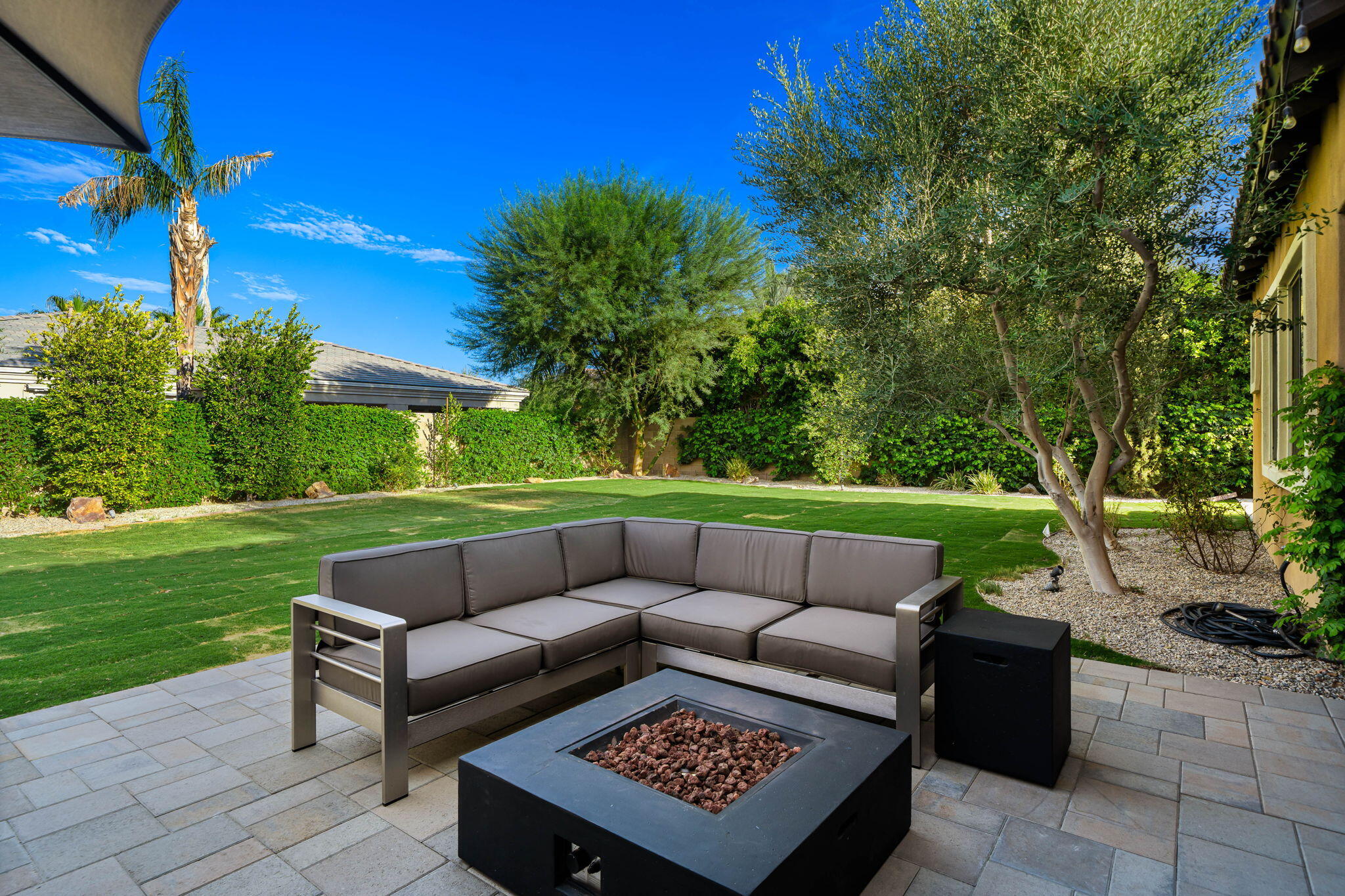 48864 Pear Street Indio, CA 92201 - Photo 45 of 46 a view of a patio with couches and a fire pit