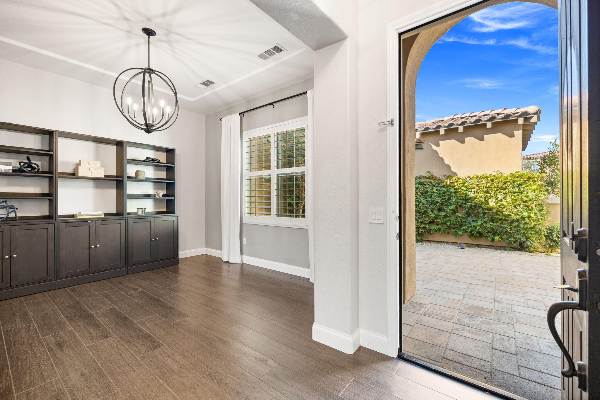 48864 Pear Street Indio, CA 92201 - Photo 8 of 46 a view of an empty room with wooden floor and a window
