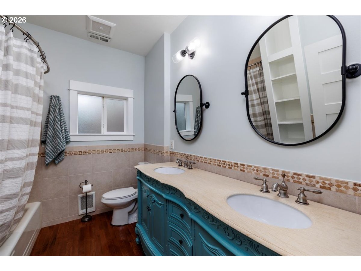3827 Southwest Dolph Court Portland, OR 97219 - Photo 15 of 48 a bathroom with a sink and a mirror