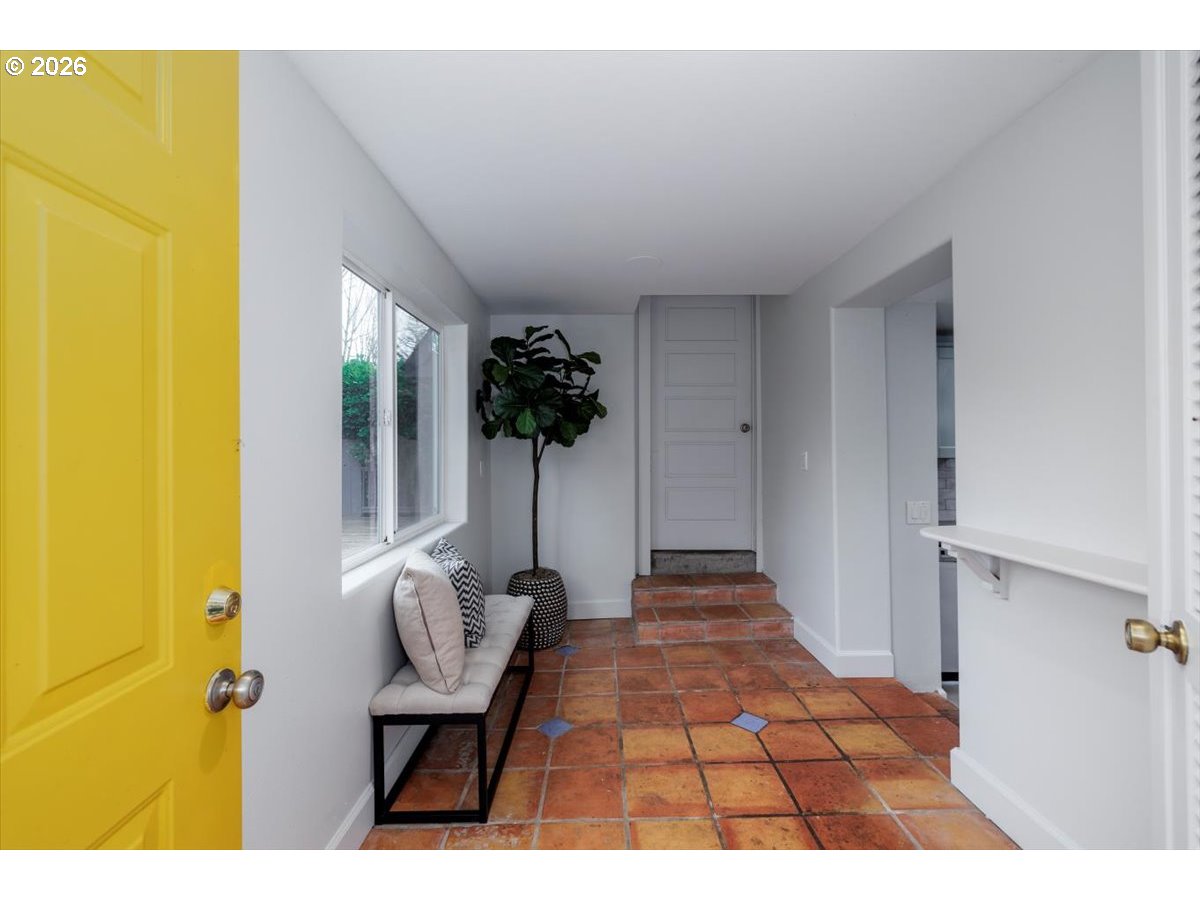 3827 Southwest Dolph Court Portland, OR 97219 - Photo 17 of 48 a picture of a room with a chair and potted plant