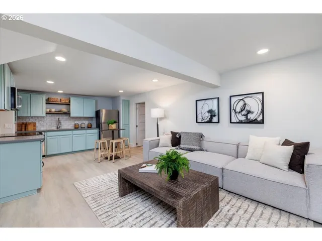 a living room with furniture and view of kitchen