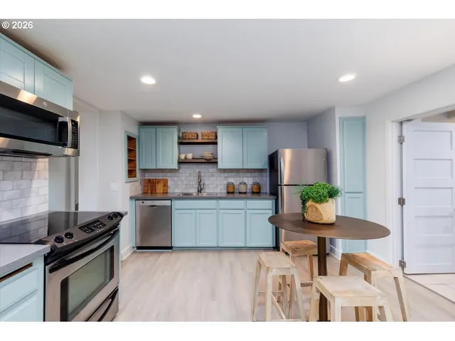 a kitchen with sink and cabinets