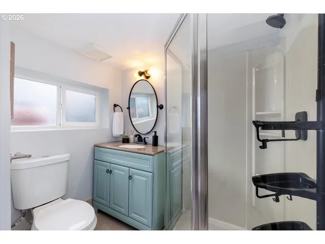 a bathroom with a toilet a sink and a mirror