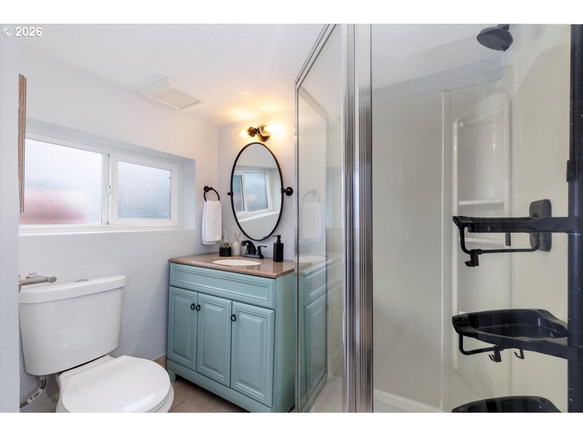 3827 Southwest Dolph Court Portland, OR 97219 - Photo 21 of 48 a bathroom with a toilet a sink and a mirror