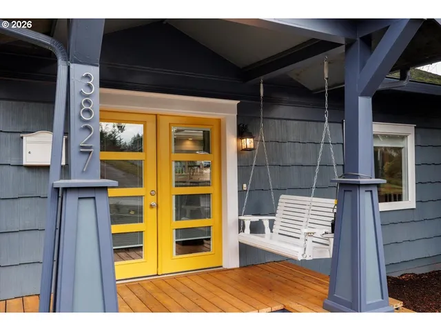 a view of empty room with wooden floor and windows