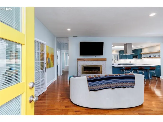 a living room with furniture a fireplace and a flat screen tv
