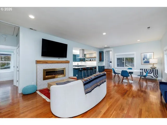 a living room with furniture a fireplace and a flat screen tv