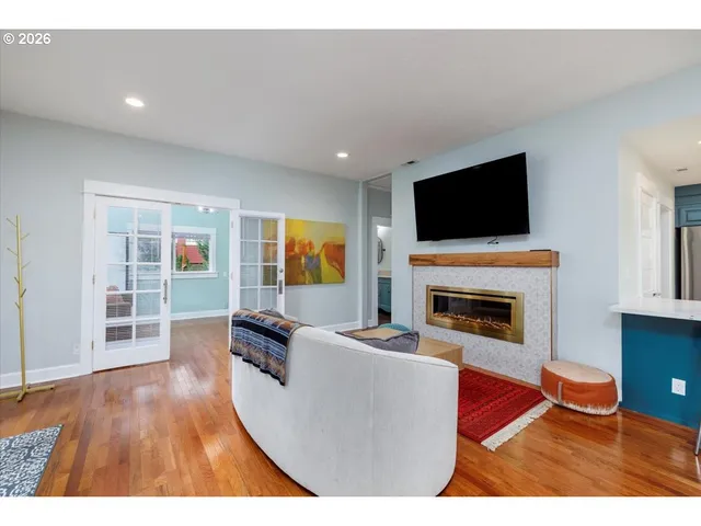 a living room with furniture a flat screen tv and a fireplace