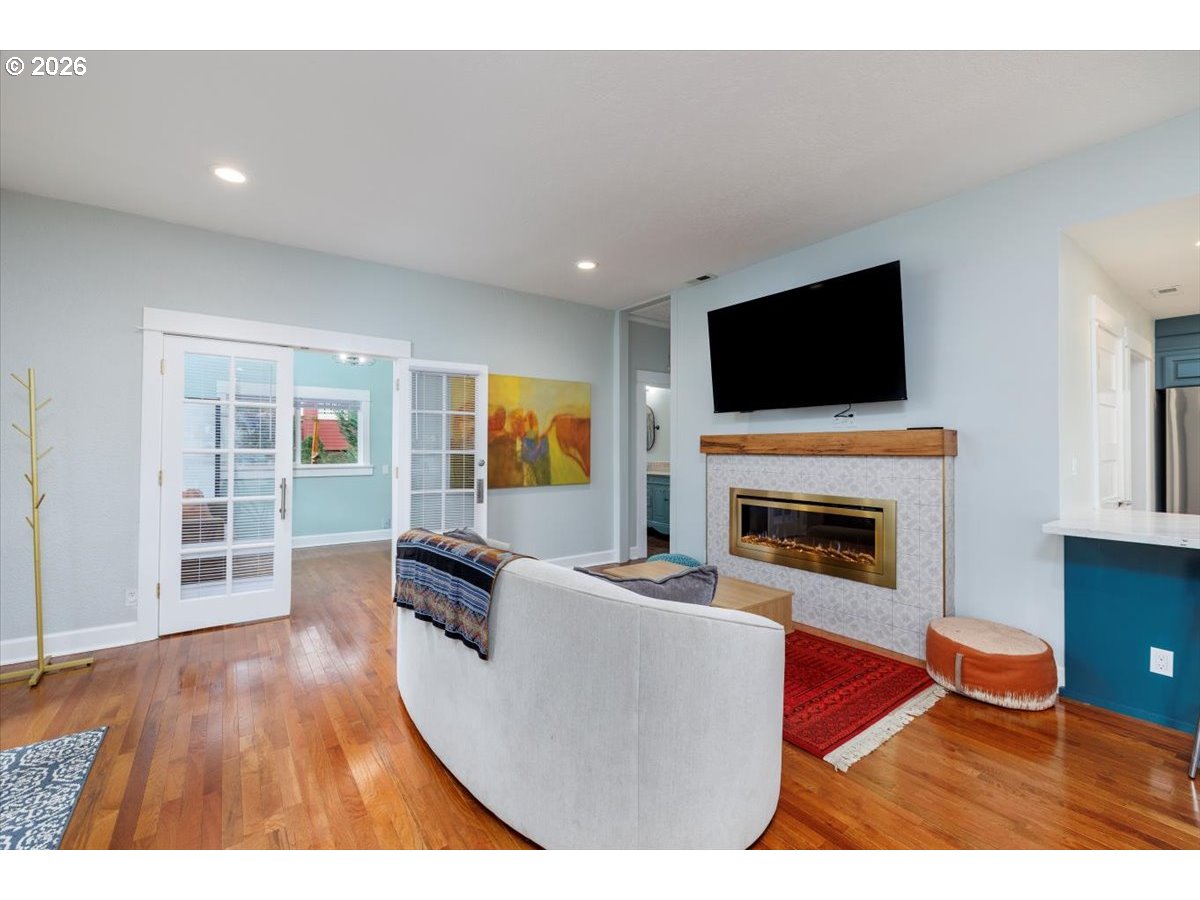 3827 Southwest Dolph Court Portland, OR 97219 - Photo 31 of 48 a living room with furniture a flat screen tv and a fireplace