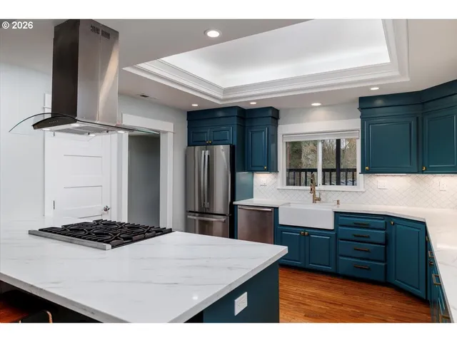 a kitchen with a sink cabinets and stainless steel appliances