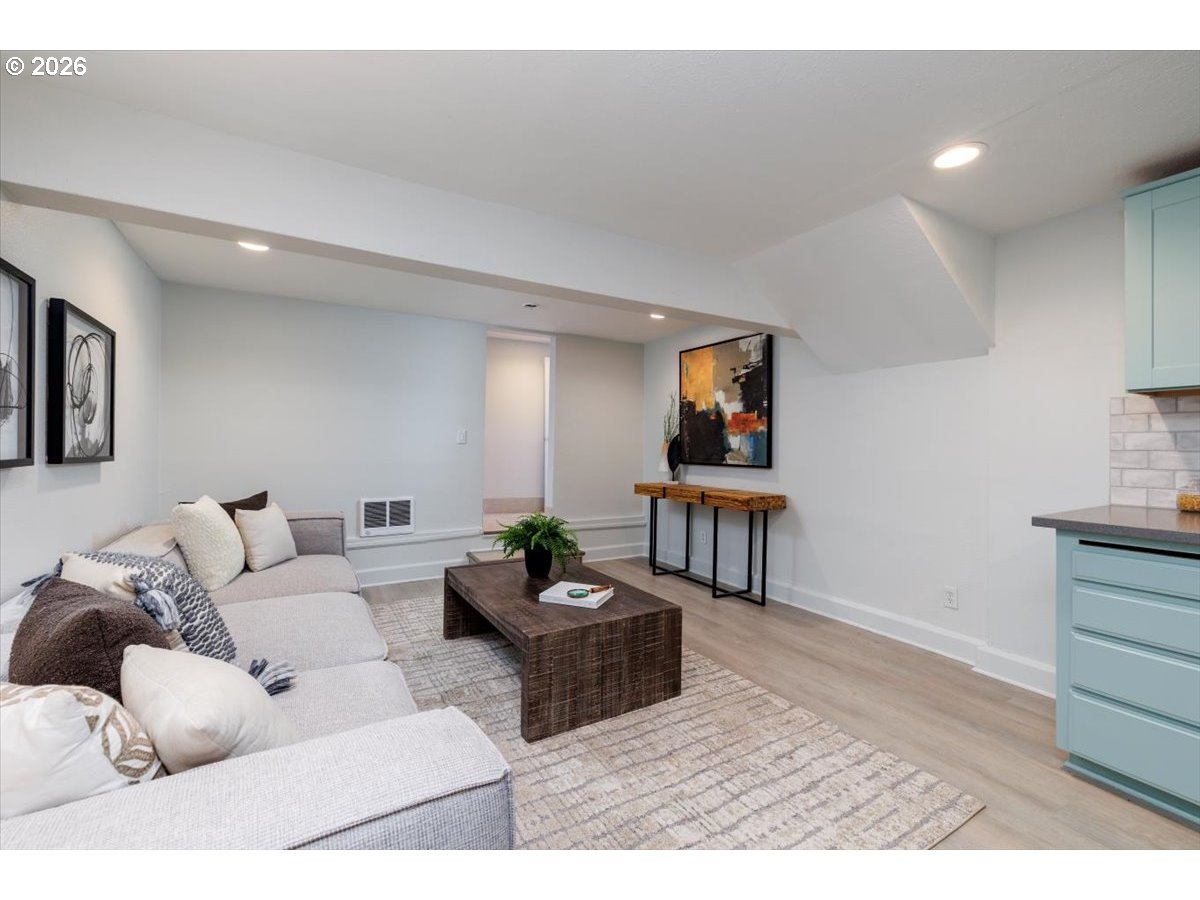 3827 Southwest Dolph Court Portland, OR 97219 - Photo 36 of 48 a living room with furniture and a wooden floor