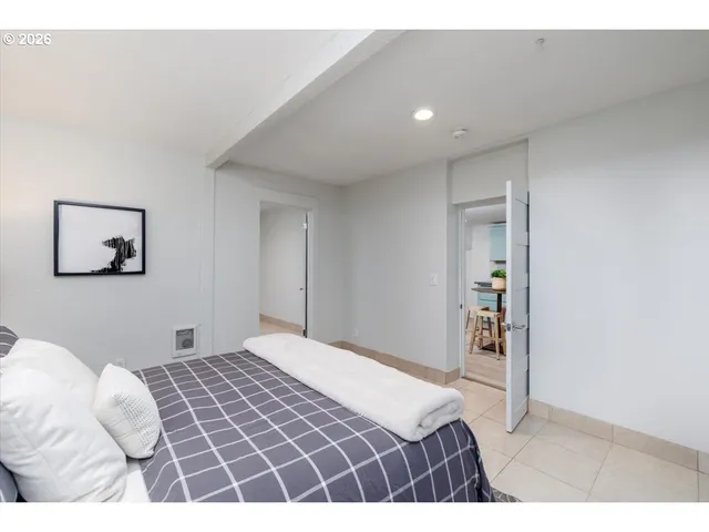 a bedroom with a large bed and a chandelier