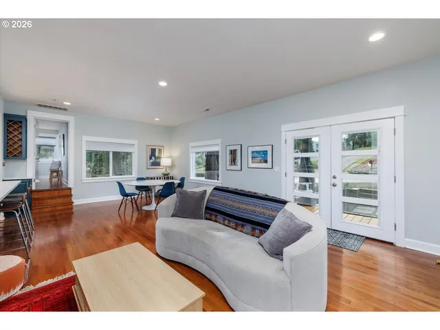 a living room with furniture and wooden floor