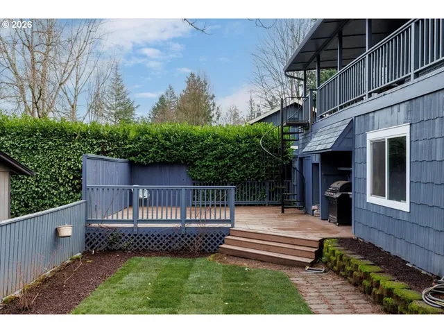 a view of backyard with a deck and wooden floor