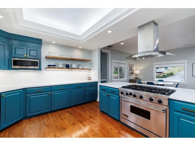 a kitchen with stainless steel appliances granite countertop wooden cabinets stove and sink
