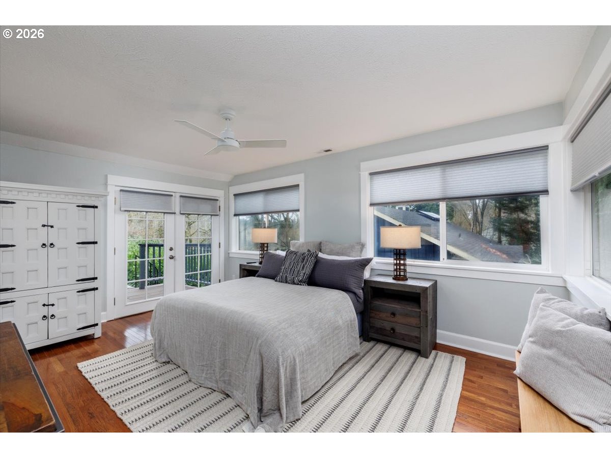 3827 Southwest Dolph Court Portland, OR 97219 - Photo 8 of 48 a bedroom with a large bed and wooden floor