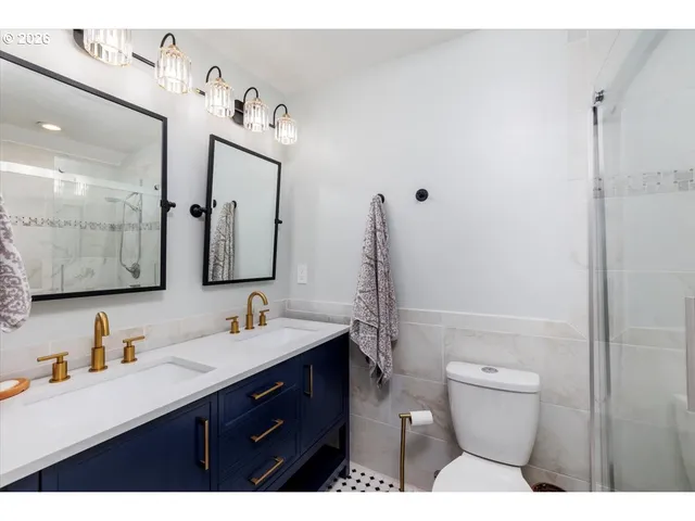 a bathroom with a sink vanity mirror and toilet