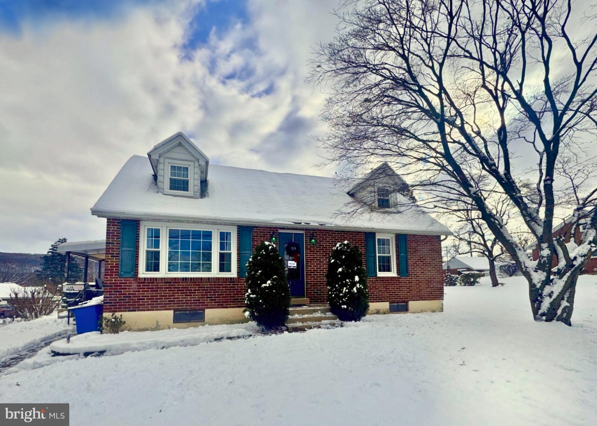 a view of a house with a snow in the yard