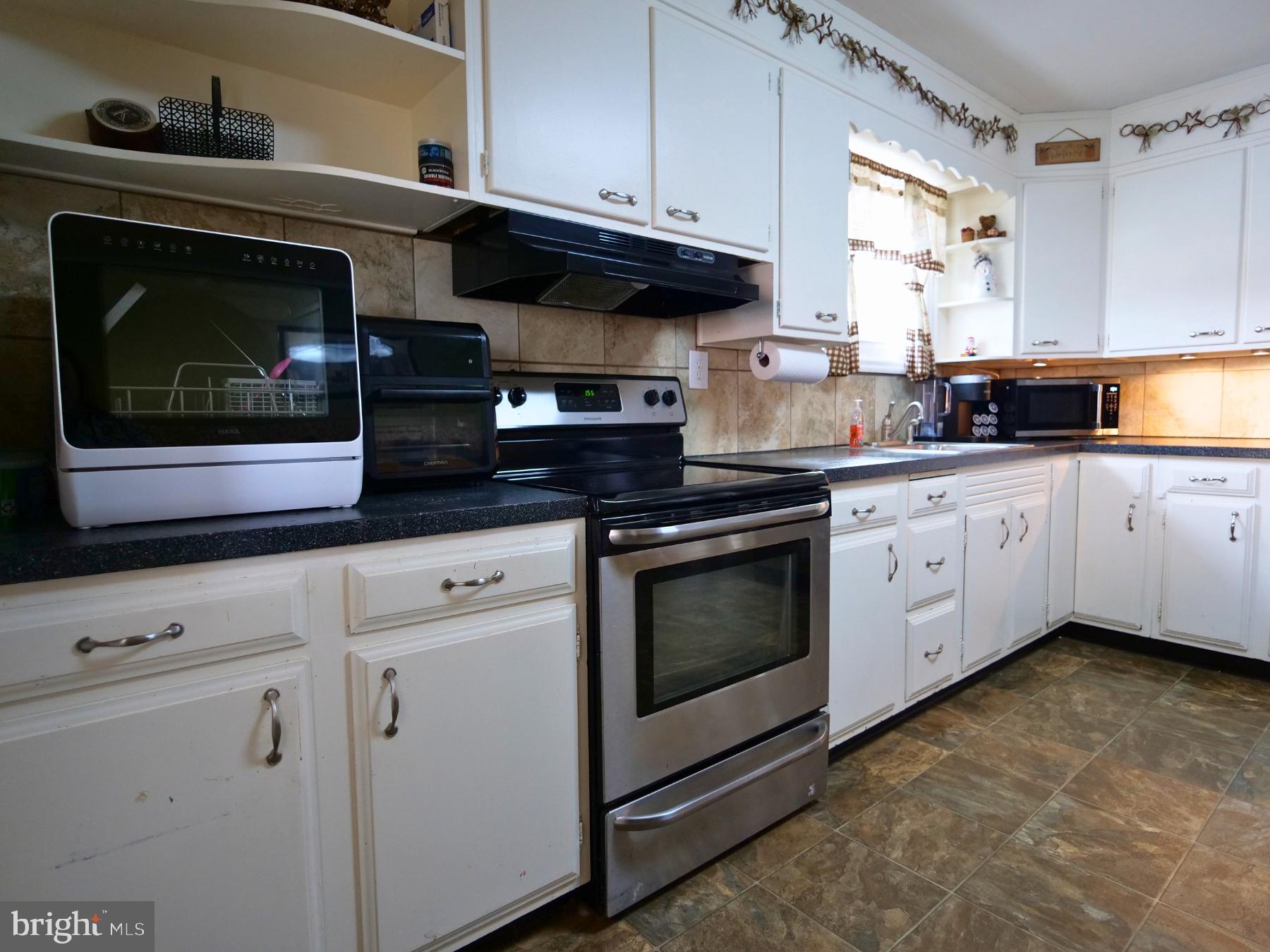 120 Harrison Street Emmaus, PA 18049 - Photo 5 of 20 a kitchen with granite countertop white cabinets stainless steel appliances and a counter space