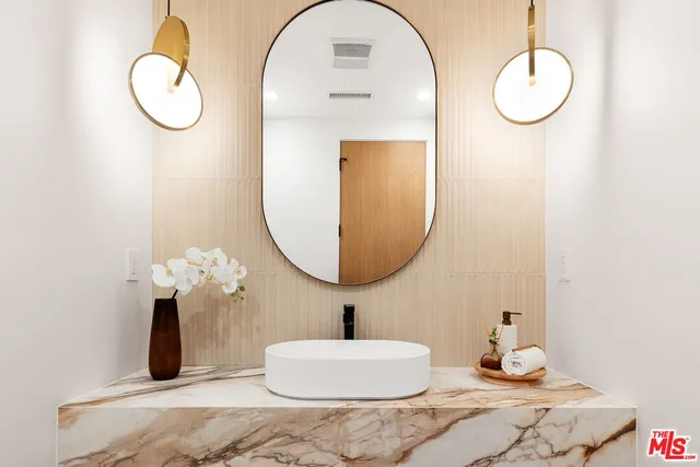 a bathroom with a double vanity sink and a mirror