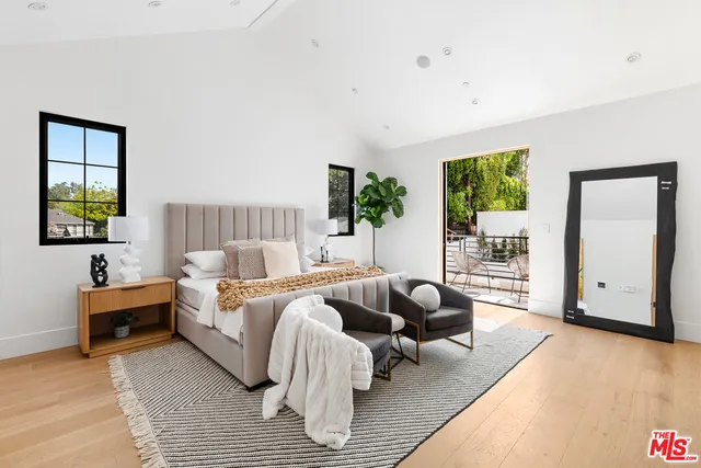 a bedroom with two beds and a window