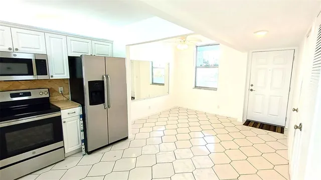 a kitchen with stainless steel appliances a refrigerator and a stove top oven