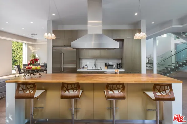 a view of a dining room with furniture and a chandelier