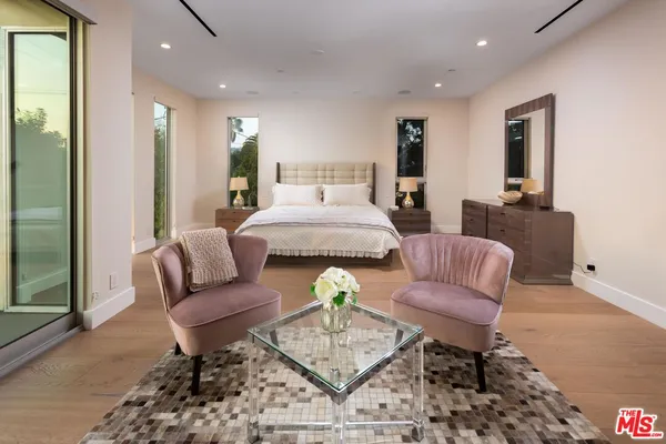 a living room with furniture and a dining table with rug