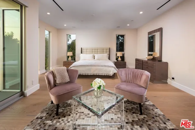 a living room with furniture and a dining table with rug