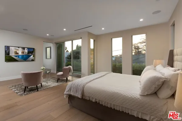 a bedroom with a large bed and a large window