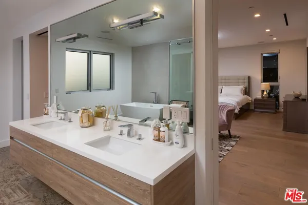 a en suite bathroom with a sink mirror and vanity