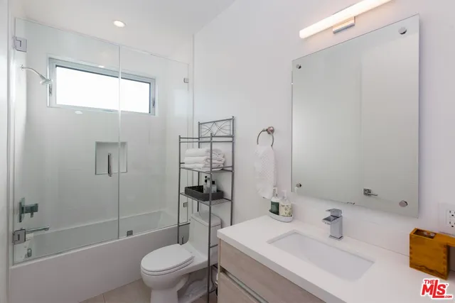 a spacious bedroom with a bed and a couch