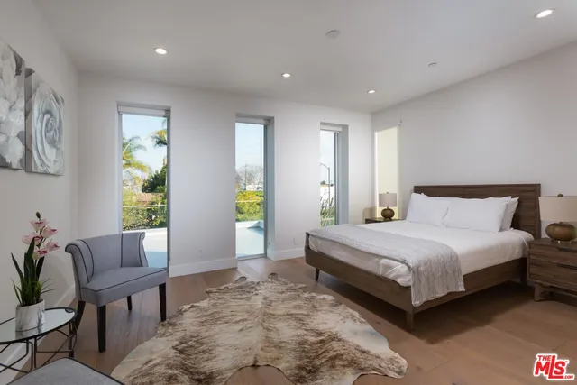 a bedroom with a bed and a chair