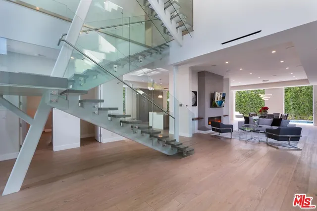 a gym room with lots of furniture and a chandelier