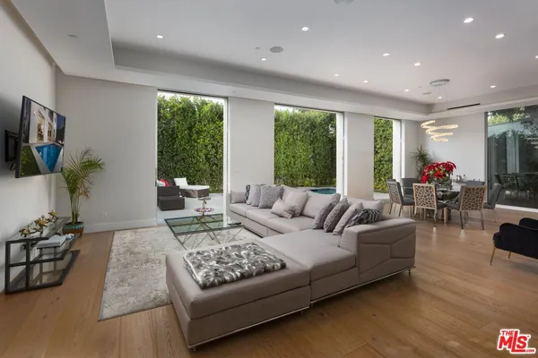a living room with furniture rug and a large window