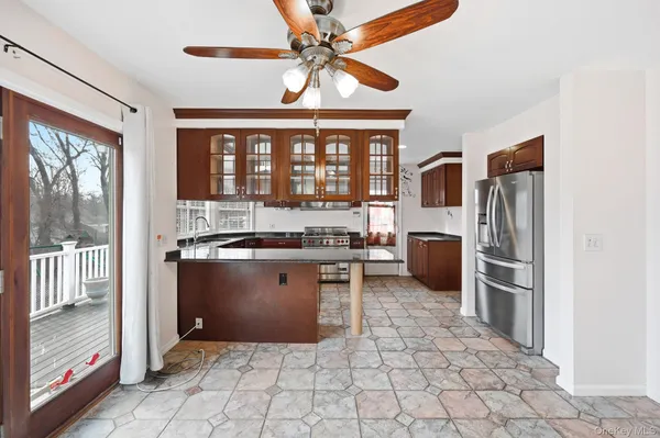a kitchen with stainless steel appliances granite countertop a refrigerator and a sink
