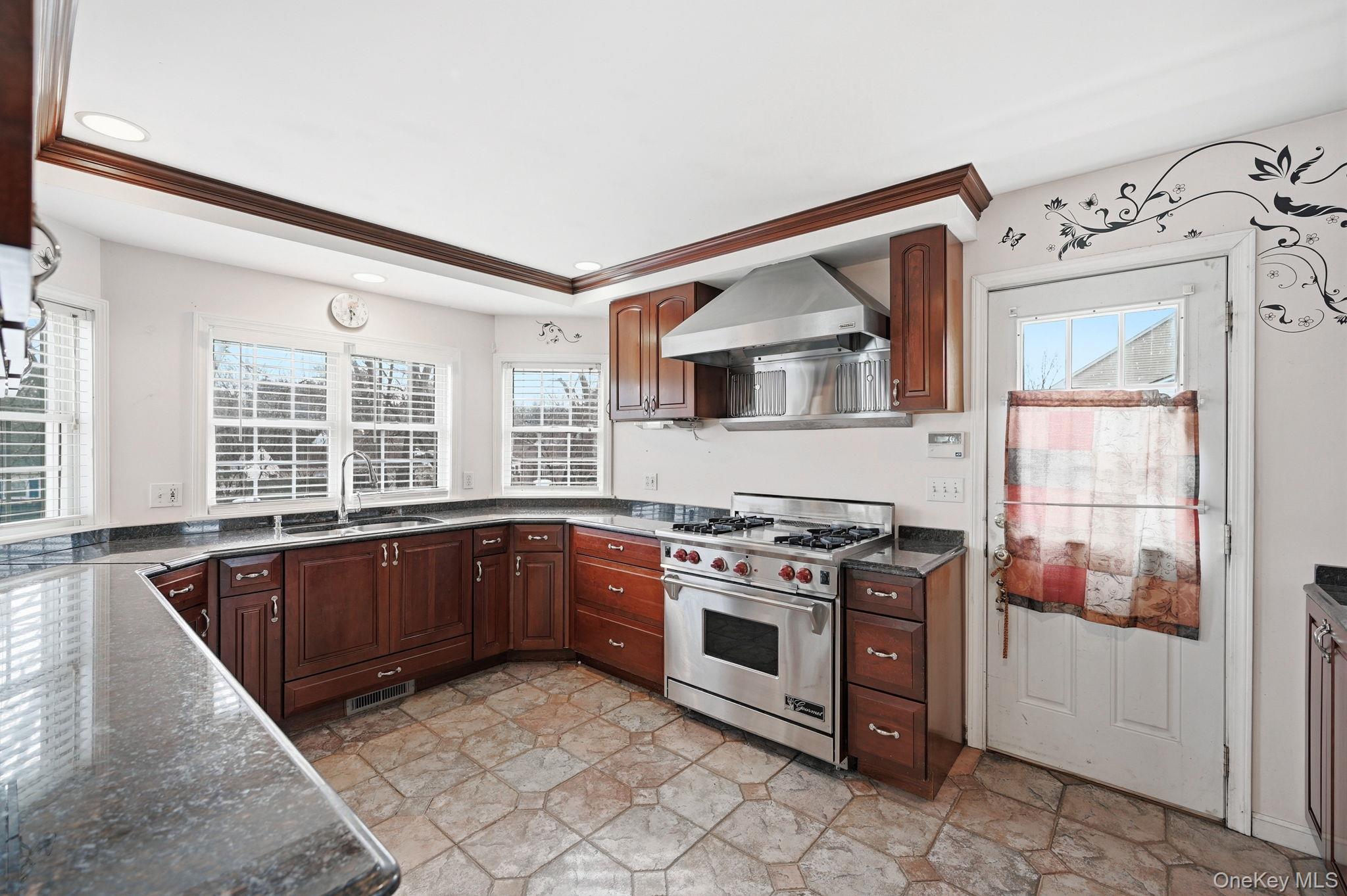186 Violet Avenue Poughkeepsie, NY 12601 - Photo 12 of 50 a kitchen with a stove a sink and a refrigerator
