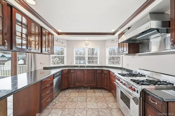 a large kitchen with stainless steel appliances granite countertop a stove and a sink