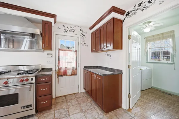a kitchen with stainless steel appliances granite countertop a stove and a refrigerator