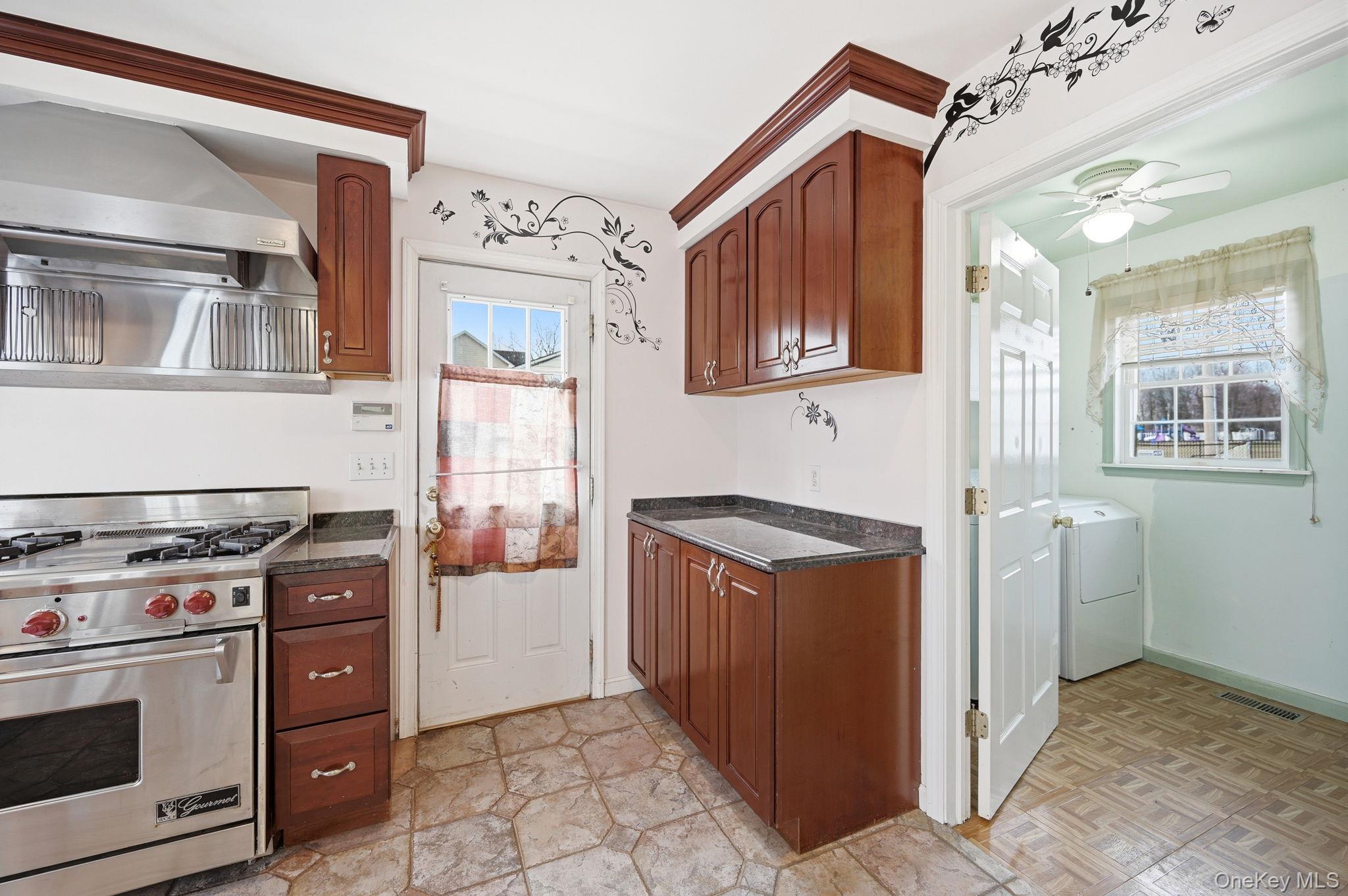 186 Violet Avenue Poughkeepsie, NY 12601 - Photo 17 of 50 a kitchen with stainless steel appliances granite countertop a stove and a refrigerator