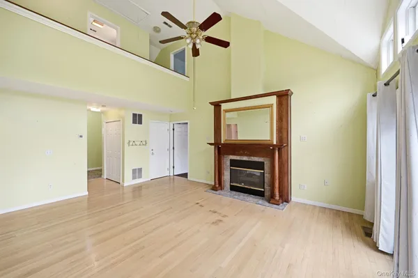 a view of a livingroom with a fireplace and a ceiling fan