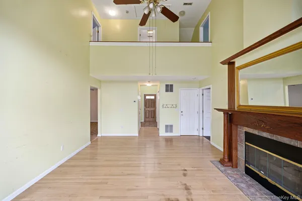 a view of a living room with a fireplace and wooden floor